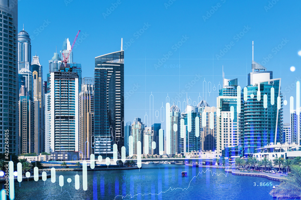 Fototapeta premium Skyscrapers of Dubai business downtown. International hub of trading and financial services of Western Asia. FOREX graph and chart concept. Double exposure. Dubai Canal waterfront.