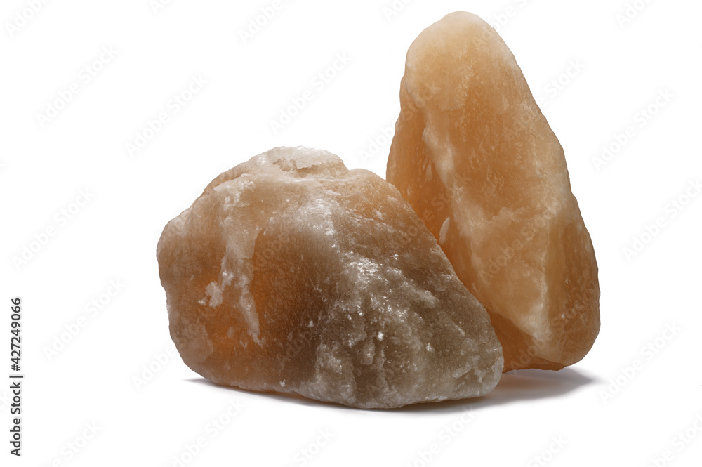 two large pieces of natural salt on a white isolated background