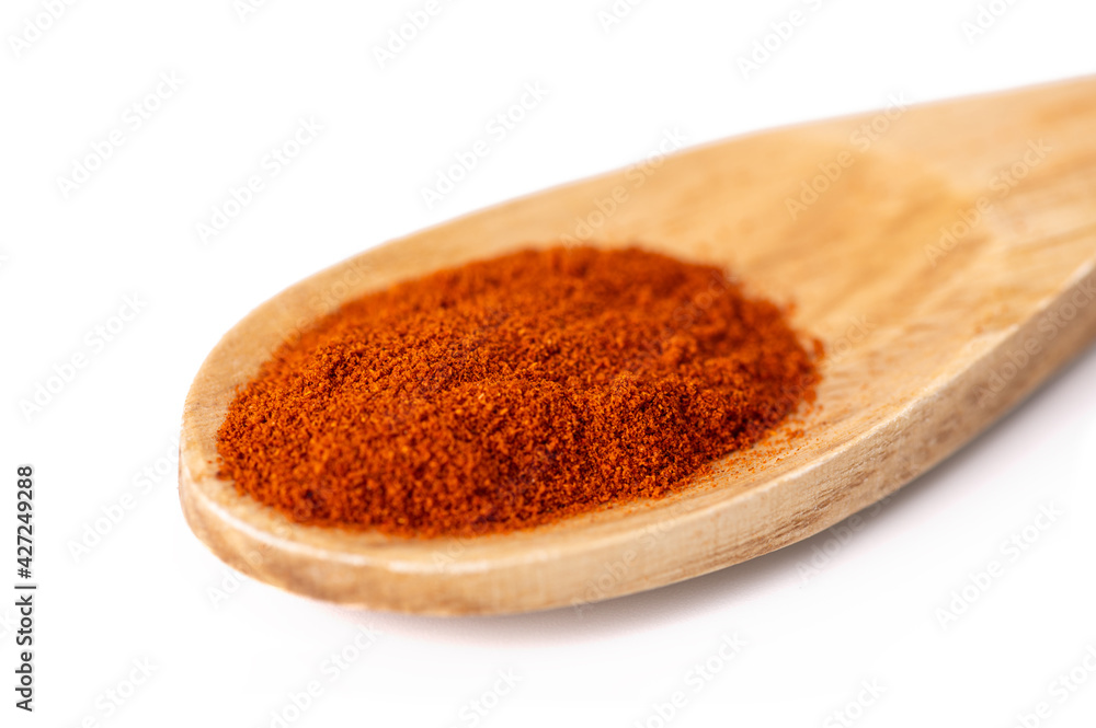 one spoon made of natural wood with aromatic seasoning on a white isolated background close-up one spoon made of natural wood with aromatic seasoning on a white isolated background close-up