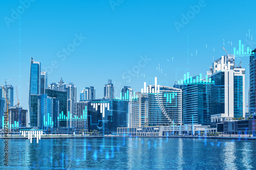 Skyscrapers of Dubai business downtown. International hub of trading and financial services of Western Asia. FOREX graph and chart concept. Double exposure. Dubai Canal waterfront.