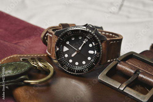 Men fashion and accessories, Wrist watch with brown leather strap, Stylish men stuff, Diving watch with wallet and belt.