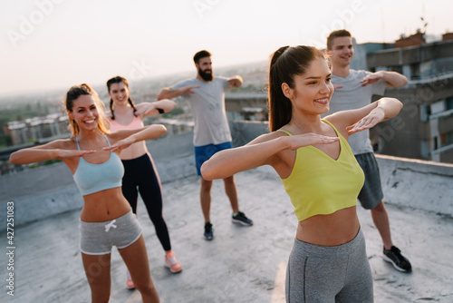 Portrait of smiling fit happy people doing power fitness exercise