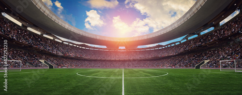 a soccer stadium in the summer in the sun photo