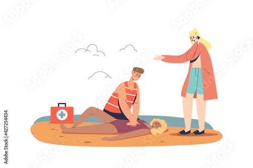 Beach lifeguard doing artificial respiration, giving first aid to woman after drowning