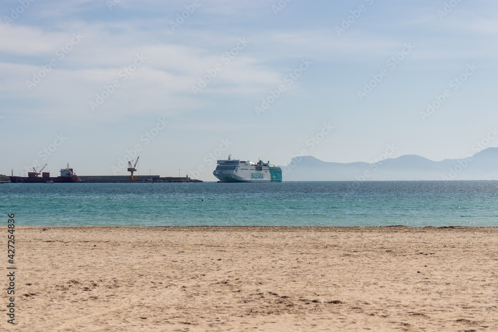 Mallorca, Spain - March, 2021: Balearia ferry ship arriving in port of alcudia in mallorca during complicated travel conditions caused by covid 19