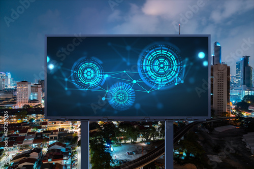 Information flow hologram on road billboard, night panorama city view of Kuala Lumpur. KL is the largest technological center in Malaysia, Asia. The concept of programming science.