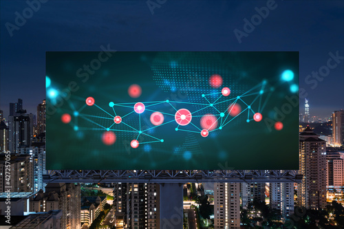 Information flow hologram on road billboard, night panorama city view of Kuala Lumpur. KL is the largest technological center in Malaysia, Asia. The concept of programming science.