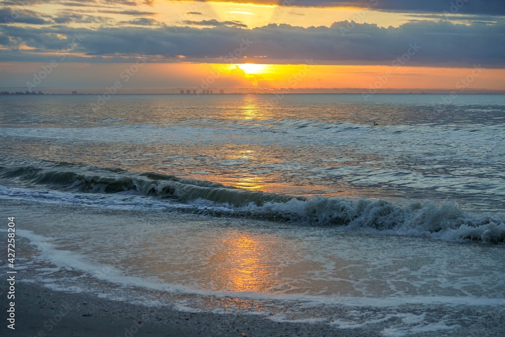 Sun rising through the clouds on Sanibel Island, Florida before Hurricane Ian