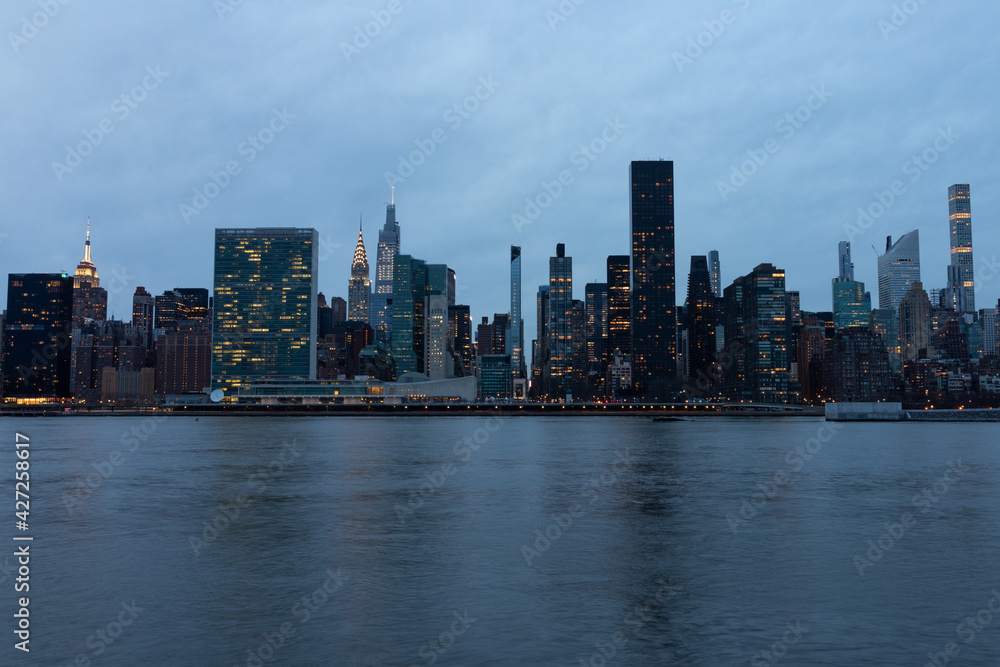 Evening Midtown Manhattan Skyline along the East River in New York City Evening Midtown Manhattan Skyline along the East River in New York City