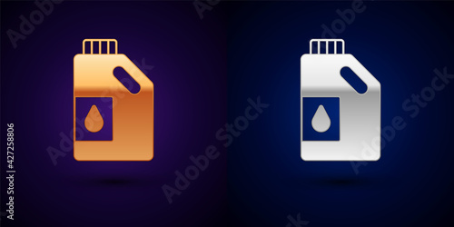 Gold and silver Canister for motor machine oil icon isolated on black background. Oil gallon. Oil change service and repair. Engine oil sign. Vector