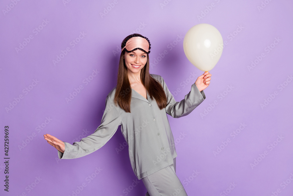 Photo portrait of girl in pajama sleeping mask keeping balloon preparing for birthday isolated on pastel purple color background Photo portrait of girl in pajama sleeping mask keeping balloon preparing for birthday isolated on pastel purple color background