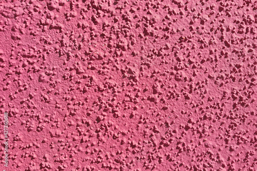 textured colored facing plaster of the street wall of the building