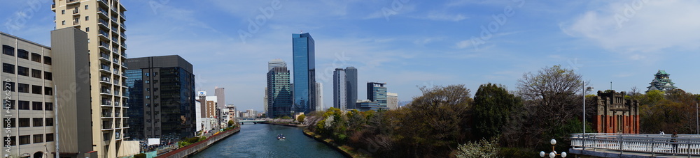 Osaka skyline along with Neya river (Neyagawa) in Japan . Panoramic view. - 寝屋川と大阪のビル群 大阪 日本