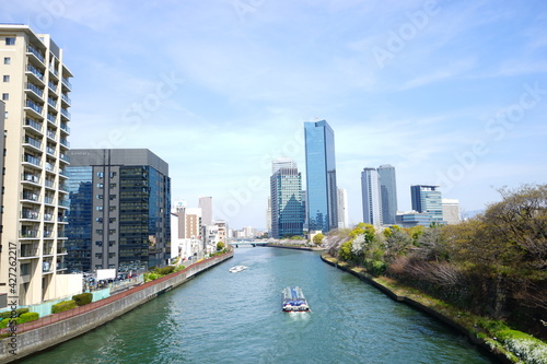 Osaka skyline along with Neya river (Neyagawa) in Japan . Panoramic view. - 寝屋川と大阪のビル群 水上バス 日本