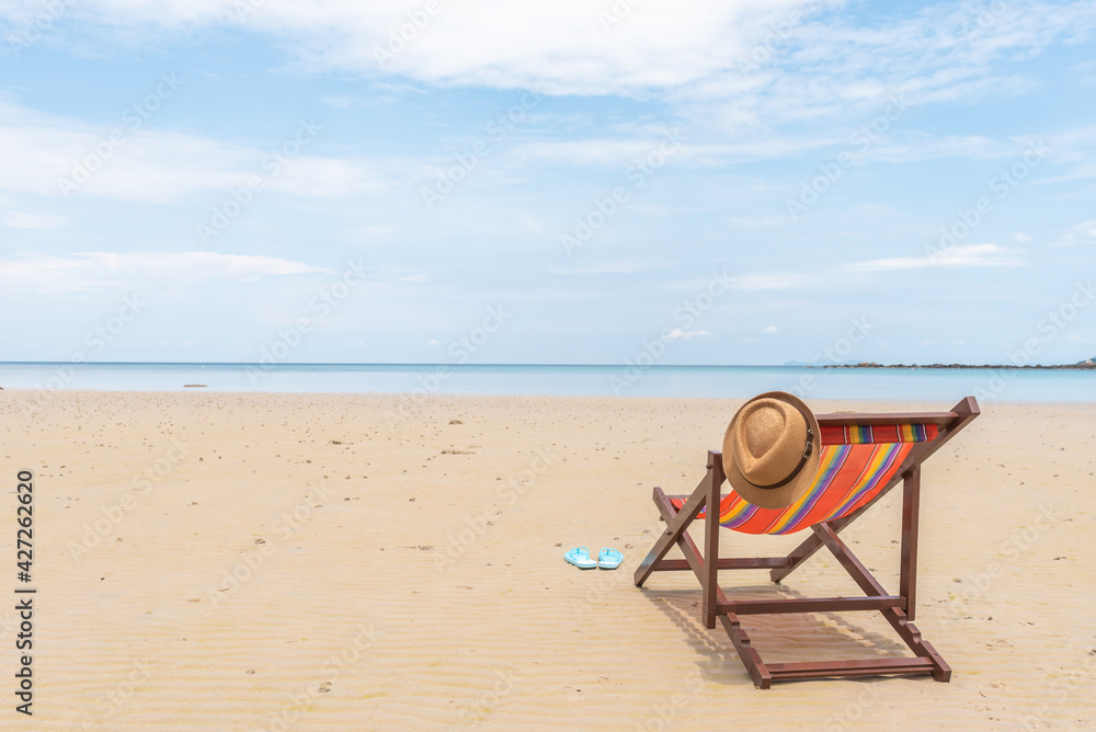 Fototapeta premium Empty beach chair on the beautiful sand beach under the clear blue sky