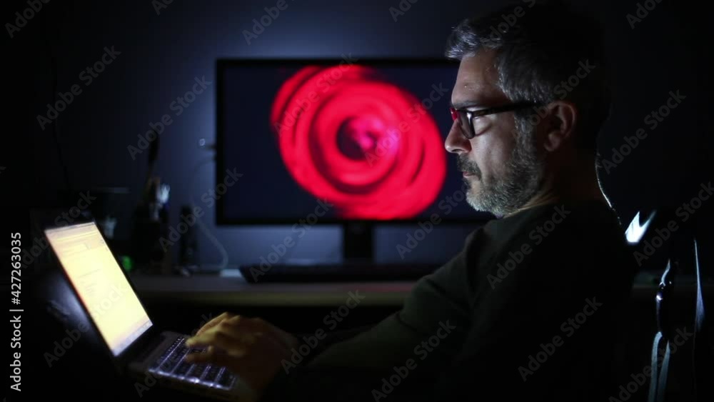 Man With Glasses Working on Computer Or Tablet Man With Glasses Working on Computer Or Tablet