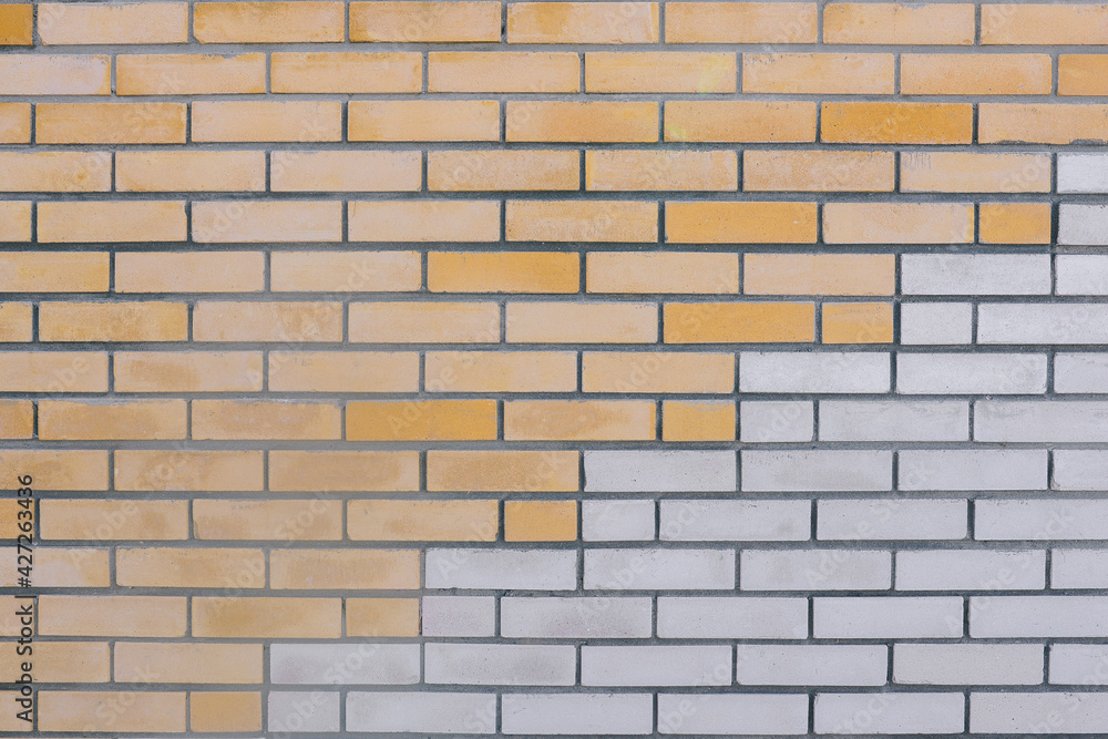 Obraz premium Brick wall. Red and white bricks. The horizontal part of the wall is made of white and yellow bricks. Brick background. Construction and interior concept