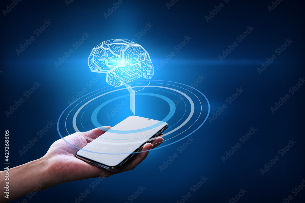 Hand with a smartphone holding a brain hologram with circles on a dark blue background. Business idea and artificial intelligence concept Hand with a smartphone holding a brain hologram with circles on a dark blue background. Business idea and artificial intelligence concept