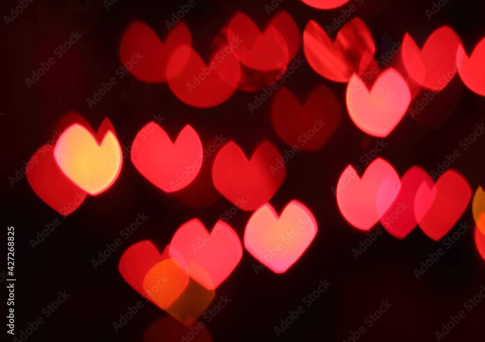 Bokeh background of colorful hearts at night