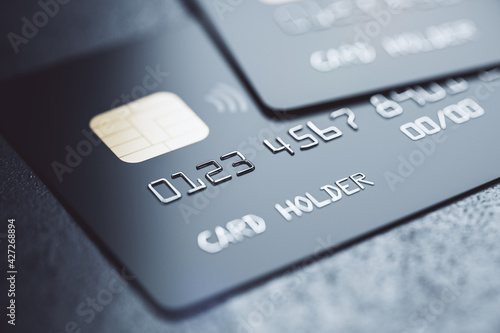 Bank system concept with black debit cards on dark background