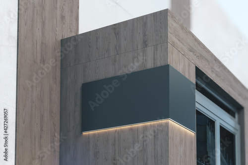 Black signboard with copyspace and backlight on the corner of eco style wooden building near entrance, 3D rendering, mock up