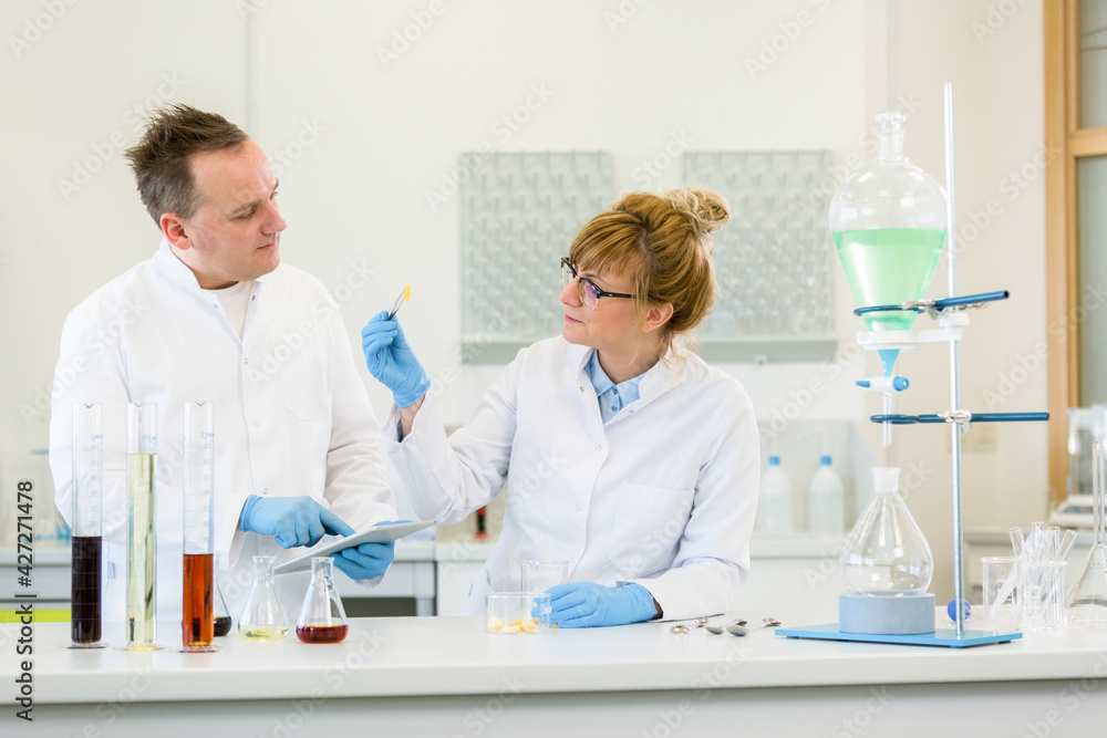 Two scientists working with terpene crystals in laboratory Two scientists working with terpene crystals in laboratory