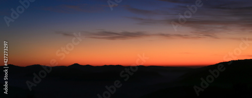 blue hour sky before sunrise with mountain silhouettes