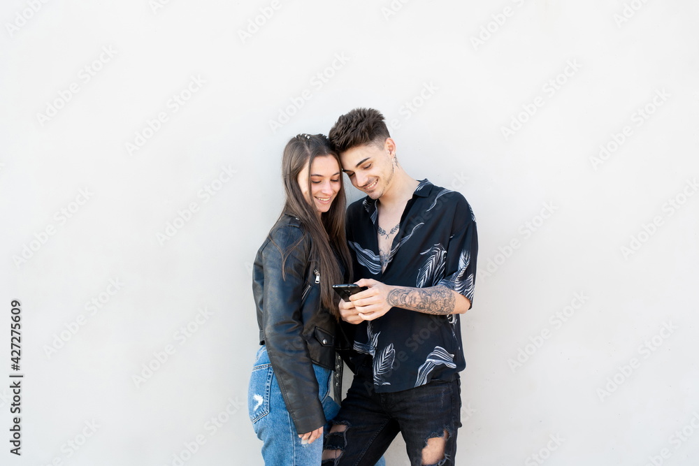 Couple looking at mobile on white background Couple looking at mobile on white background