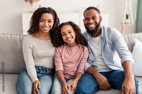 Portrait of a happy black family smiling at home © Prostock-studio