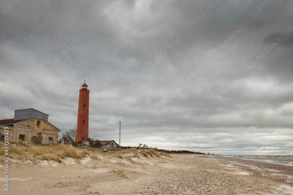 The old Akmenraga lighthouse on the shores of the Baltic Sea