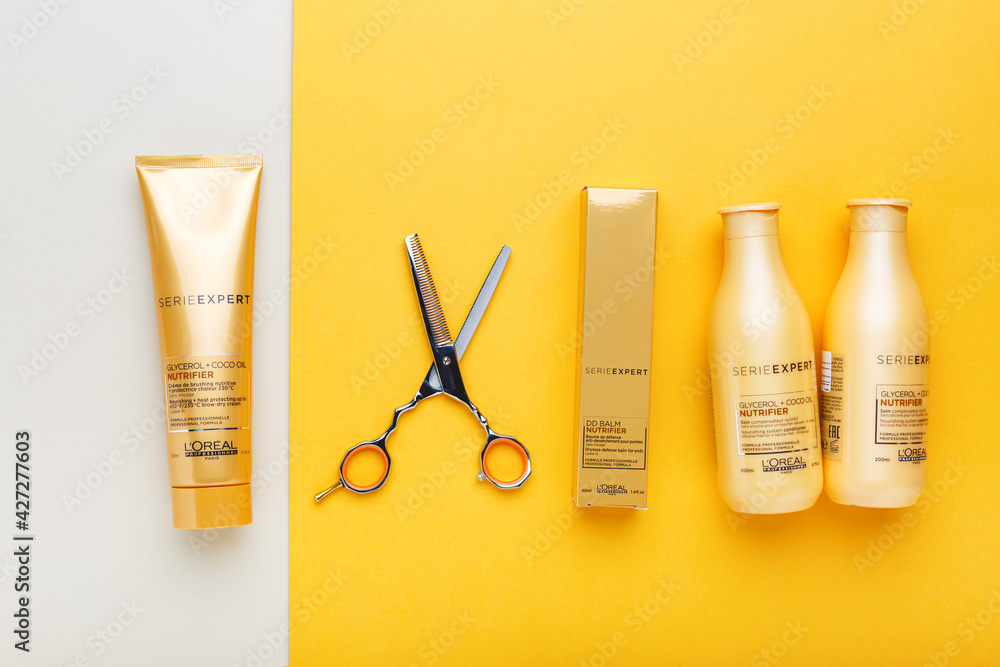 L'oreal professionnel Paris Serie Expert loreal nutrifier hair professional  products set hairdressing scissors. Loreal hair shampoo mask on yellow  color background. Gold cosmetics bottles. Flat lay Stock Photo | Adobe Stock