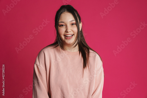 Asian brunette woman smiling and looking at camera © Drobot Dean