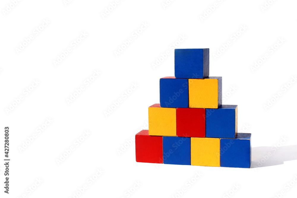 Children's toy. Bright multi-colored cubes are stacked in a pyramid. Children's toy. Bright multi-colored cubes are stacked in a pyramid.