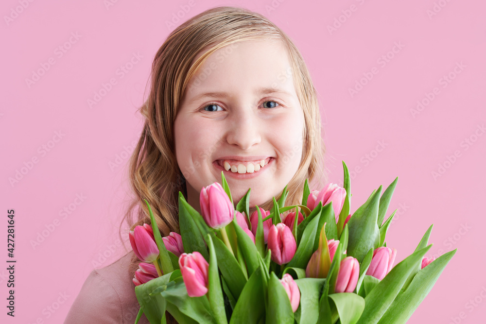 Portrait of smiling child with long wavy blond hair on pink Portrait of smiling child with long wavy blond hair on pink