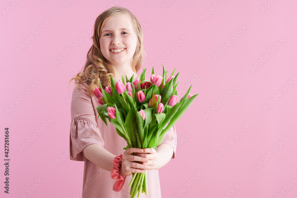happy stylish child in pink dress on pink