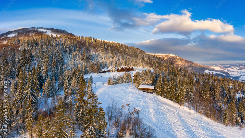 Magical winter panorama of beautiful snowy slopes at a ski resort in Europe on a sunny, windless frosty day. The concept of active recreation in winter