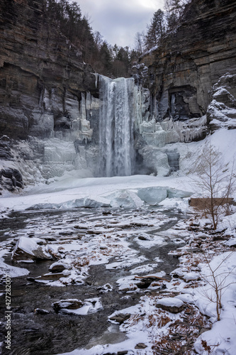 Taughannock Falls, a 215-foot (66 m) plunge waterfall that is the highest single-drop waterfall east of the Rocky Mountains, forms icles during a winter day.