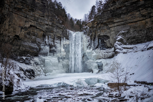 Taughannock Falls, a 215-foot (66 m) plunge waterfall that is the highest single-drop waterfall east of the Rocky Mountains, forms icles during a winter day. photo