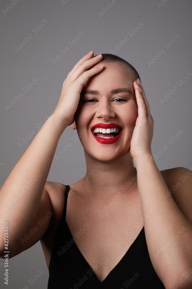 Portrait of a happy, beautiful and bald woman, vertical shot. Portrait of a happy, beautiful and bald woman, vertical shot.
