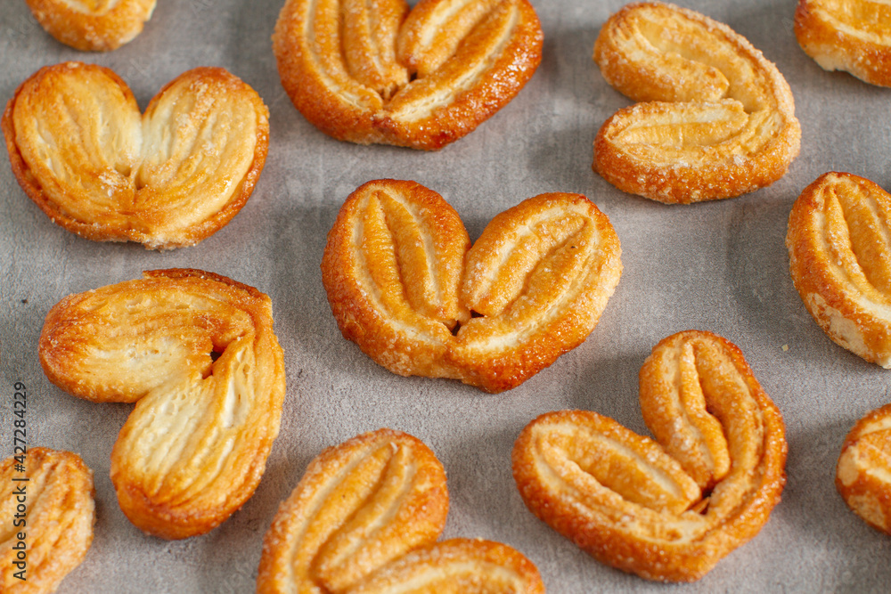 Fresh puff pastry cookies in  shape of a heart. Classic French pastries