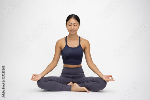 Young Asian woman doing yoga practice isolated on white background. Full length composition
