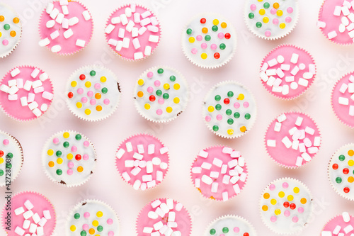 Colorful cupcakes on a white background.