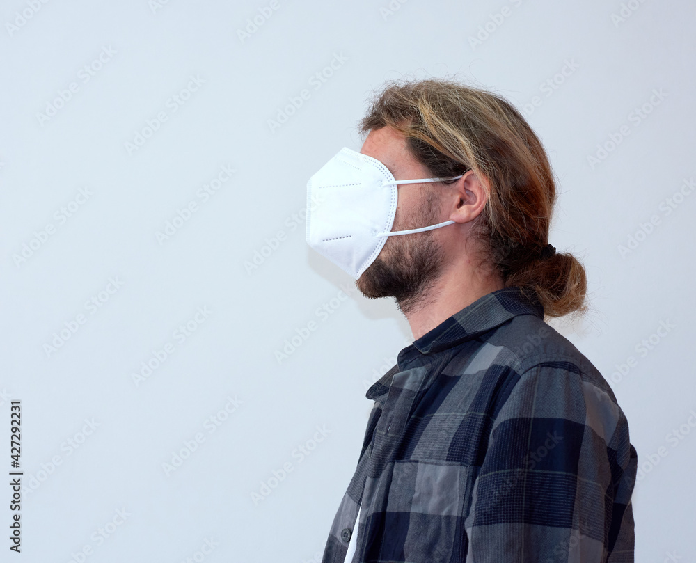 A Spanish young bearded male wearing a protective facemask incorrectly -COVID-19 A Spanish young bearded male wearing a protective facemask incorrectly -COVID-19