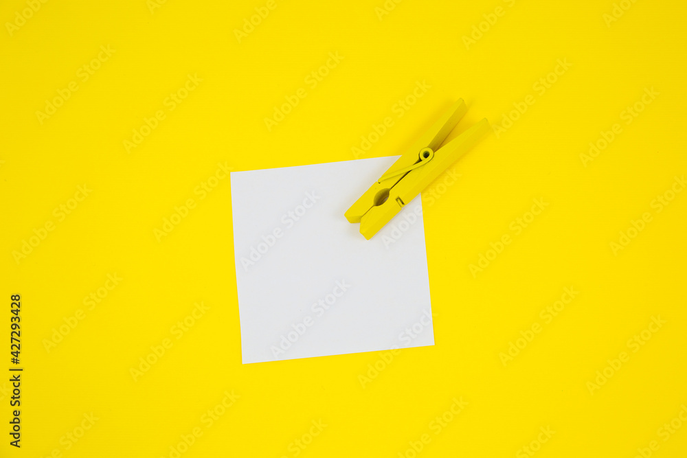 Blank white To Do List Sticker with yellow wooden clothespin. Close up of reminder note paper on the yellow background. Copy space. Minimalism, original and creative photo. Blank white To Do List Sticker with yellow wooden clothespin. Close up of reminder note paper on the yellow background. Copy space. Minimalism, original and creative photo.