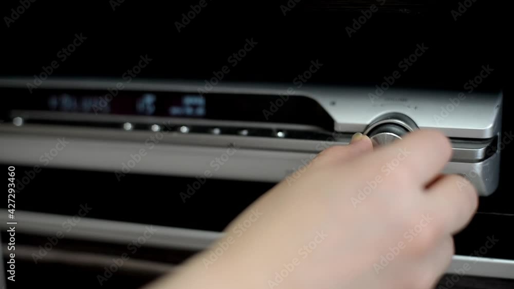 close-up of adjusting the sound on the turntable. a woman's hand adds sound to the music. close-up of adjusting the sound on the turntable. a woman's hand adds sound to the music.