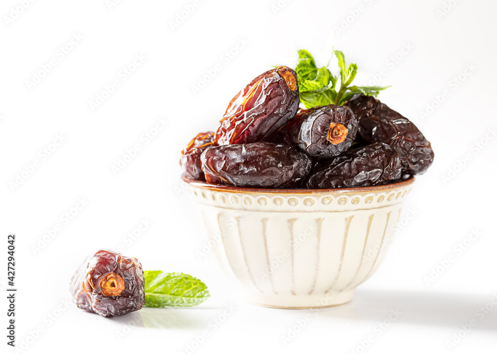 Dates fruit and rosary still life against on white background. Ramadan background greeting card. Ramadan Kareem. Dates fruit and rosary still life against on white background. Ramadan background greeting card. Ramadan Kareem.