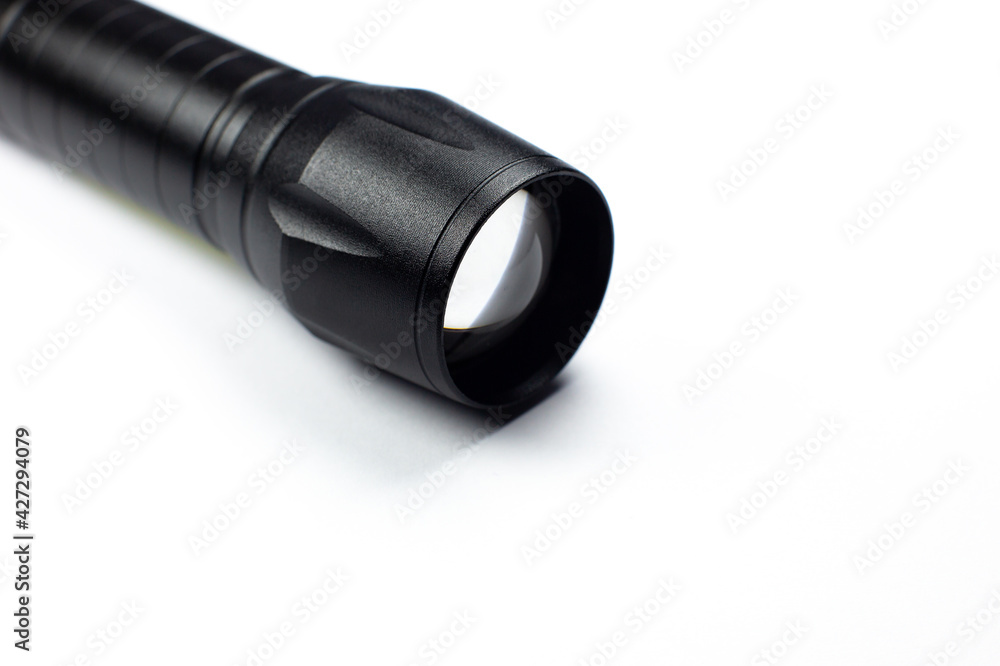 Black Flashlight on the white background. Close up. Black Flashlight on the white background. Close up.