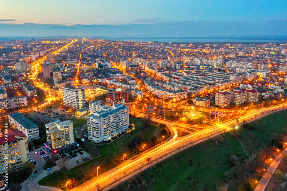 Galati, ROMANIA - March 19, 2021: Aerial view of Galati City, Romania. Night city lights after sunset at blue hour