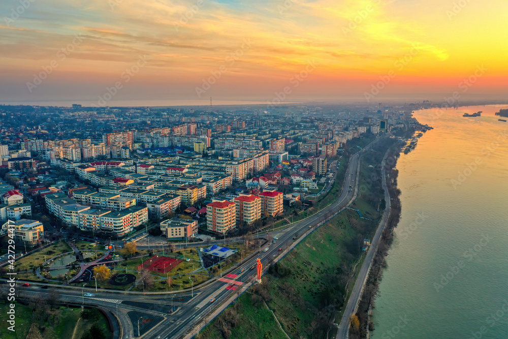 Galati, ROMANIA - March 19, 2021: Aerial view of Galati City, Romania. Danube River near city with sunrise warm light