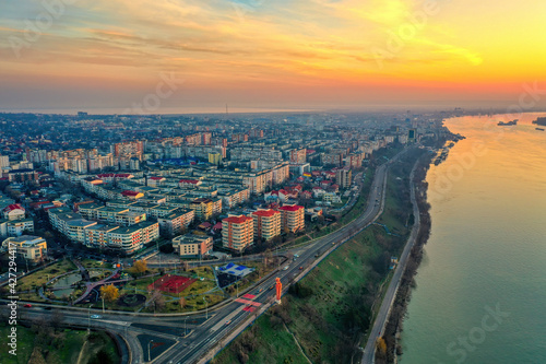 Galati, ROMANIA - March 19, 2021: Aerial view of Galati City, Romania. Danube River near city with sunrise warm light